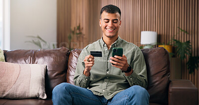 Buy stock photo Debit card, phone and man on sofa in home with online shopping, ecommerce or purchase on website. Technology, credit and male person with cellphone for paying bills with internet banking in house.