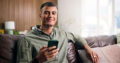 Buy stock photo Man, phone and relax with smile on couch in home for texting, web chat or online dating in lounge. Person, smartphone and happy in portrait, contact or social network on sofa at apartment in Mexico