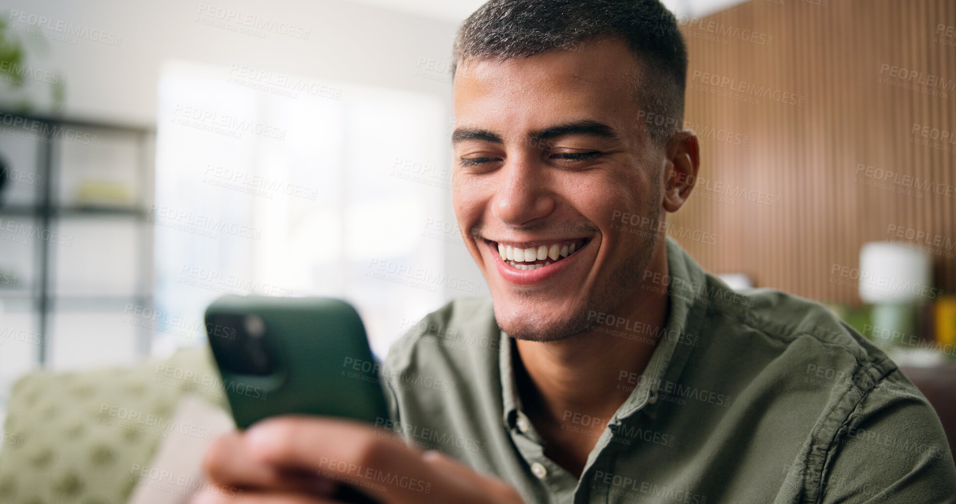 Buy stock photo Laugh, happy and man on sofa with phone for social media, online dating and message in home. Weekend, house and person on smartphone for internet, connection and chat for notification on mobile app