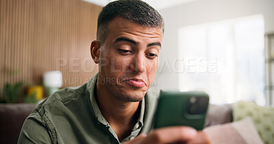 Buy stock photo Typing, doubt and man on sofa with phone for social media, online dating and contact in home. Weekend, unsure and person on smartphone for internet, notification and reading odd message on mobile app
