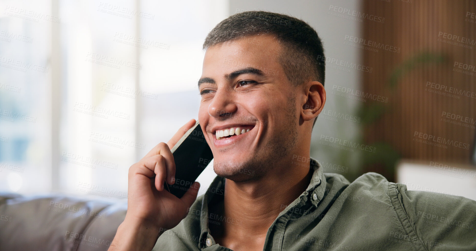 Buy stock photo Man, phone call and relax on sofa with smile, happy and chat or gossip in home living room. Person, smartphone and conversation on couch with social networking, communication and speaking in lounge