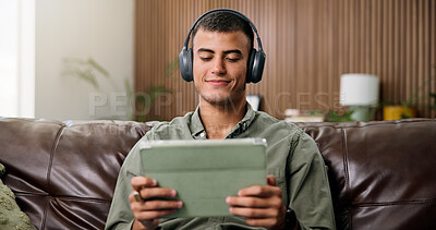 Buy stock photo Happy, tablet and man on sofa with headphones for online videos, subscription and watching movies. Home, audio and person on digital tech for internet, website and streaming to relax on weekend