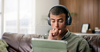 Buy stock photo Surprise, tablet and man on sofa with headphones for online videos, subscription or watching movies. Home, shock and person on digital tech for internet, website and streaming drama series on weekend
