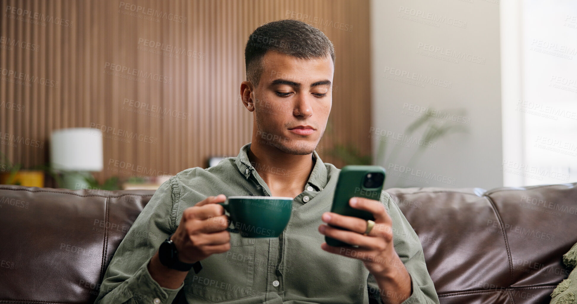 Buy stock photo Relax, coffee and man on sofa with phone for social media, online message and chat in home. Reading, notification and person on smartphone with drink for internet, connection and chill on weekend
