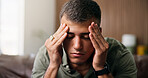 Frustrated, man and stress with anxiety in home for loneliness, mistake or mental health on sofa. Tired, migraine or male person with depression or headache for fatigue, pressure or strain in house