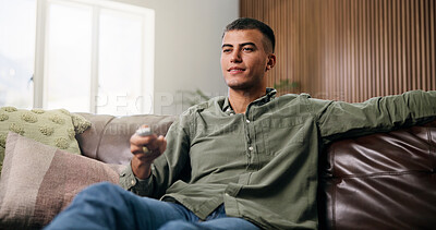 Buy stock photo Choice, remote and man on sofa for watching tv, movie or series in living room for weekend. Relax, subscription and male person in home for streaming film, channel and television show in apartment