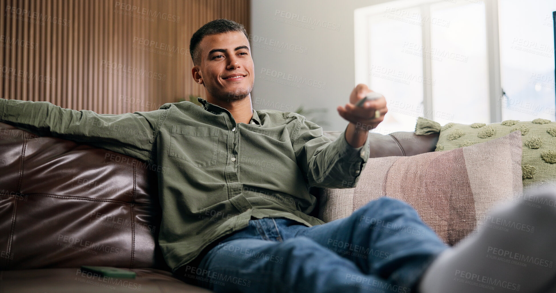 Buy stock photo Relax, remote and man on sofa for watching tv, movie, show or series in living room for weekend. Choice, subscription and male person in home for streaming film, channel and television in apartment