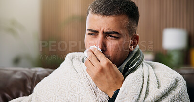 Buy stock photo Man, tissue and blowing nose on sofa with blanket for comfort, flu and rest with recovery at home. Person, illness and cold symptoms with congestion, tired or allergies in living room at apartment