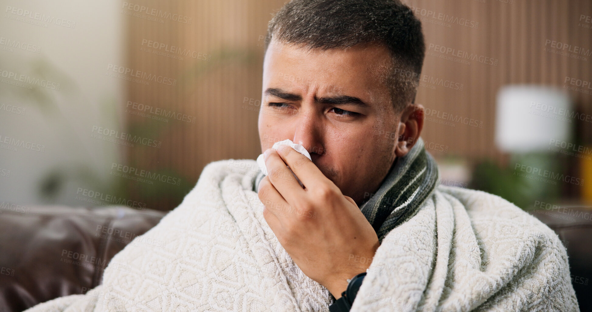 Buy stock photo Man, tissue and blowing nose on sofa with blanket for comfort, flu and rest with recovery at home. Person, illness and cold symptoms with congestion, tired or allergies in living room at apartment