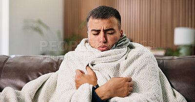 Buy stock photo Man, sick and rest with blanket on sofa with cold symptoms, virus and fatigue in living room at house. Person, flu or illness on couch with comfort, break and recovery for healing at apartment