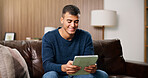 Man, tablet and smile on sofa for social media, communication or entertainment in home living room. Male person, typing and relax on lounge couch with technology for online streaming and search