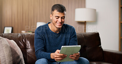 Buy stock photo Man, tablet and smile on sofa for social media, communication or entertainment in home living room. Male person, typing and relax on lounge couch with technology for online streaming and search
