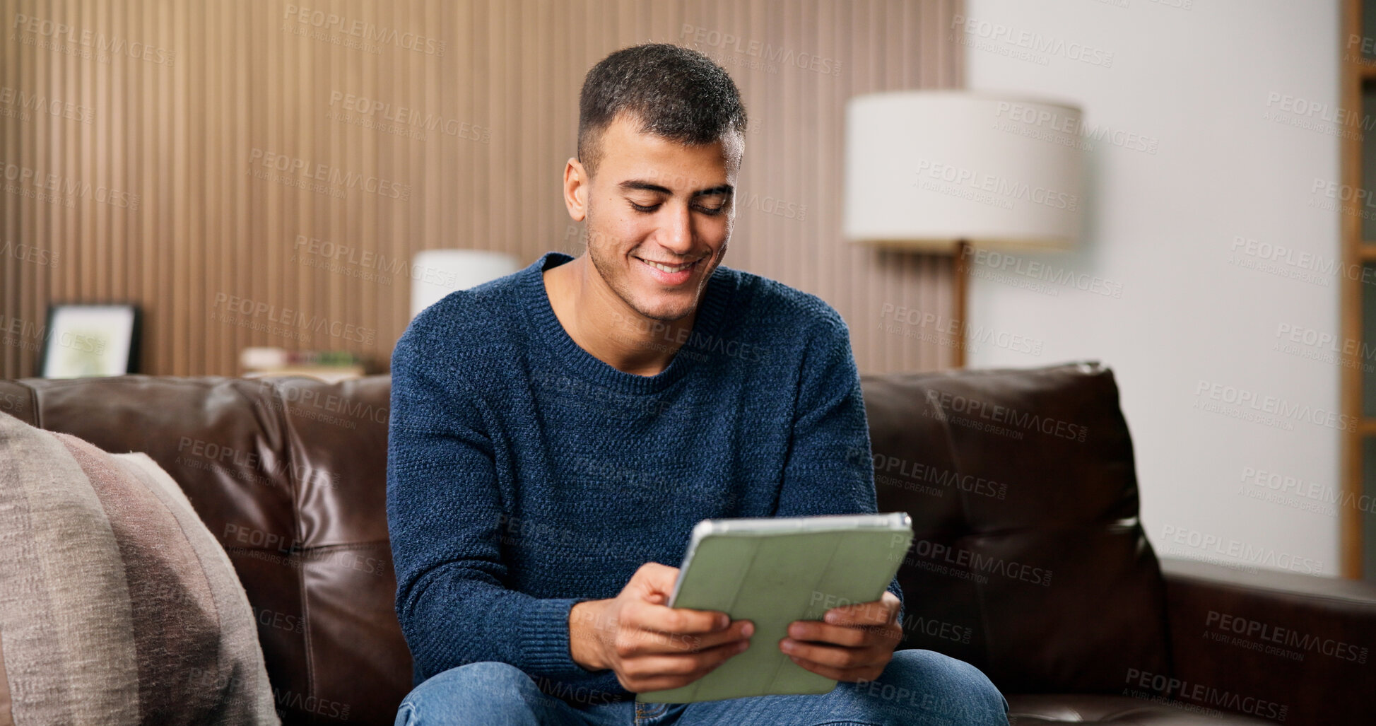 Buy stock photo Man, tablet and smile on sofa for social media, communication or entertainment in home living room. Male person, typing and relax on lounge couch with technology for online streaming and search