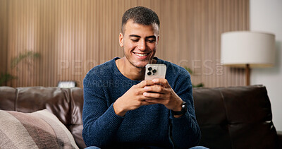 Buy stock photo Typing, happy and man on sofa with phone for social media, online message and chat in home. Weekend, laugh and person on smartphone for internet, connection and reading notification on mobile app