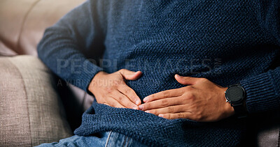 Buy stock photo Man, hands or stomach ache with pain for indigestion, constipation or diarrhea on sofa in home. Closeup, male person or sore belly with gastrointestinal reflux for virus or bladder infection in house