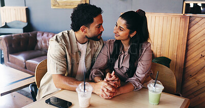 Buy stock photo Couple, holding hands and milkshake on date at coffee shop with connection, love and bonding. Man, woman and partner at cafe for drinks with relationship, smile or trust with loyalty at restaurant
