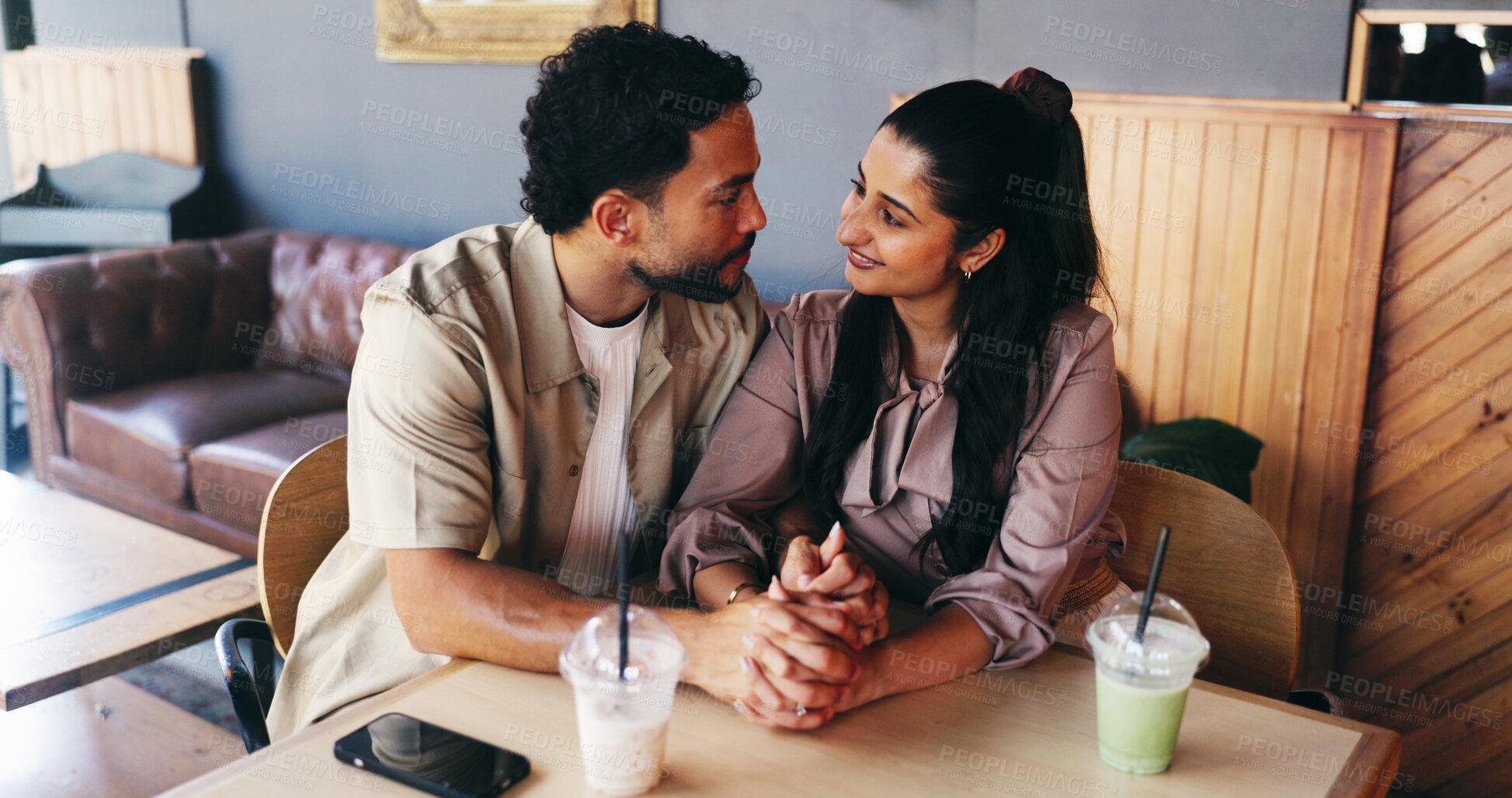 Buy stock photo Couple, holding hands and milkshake on date at coffee shop with connection, love and bonding. Man, woman and partner at cafe for drinks with relationship, smile or trust with loyalty at restaurant