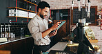 Waiter, man and scroll in restaurant with tablet, booking website or notification for online order. Person, reading and browse in diner with tech, hospitality service and check email for reservation.