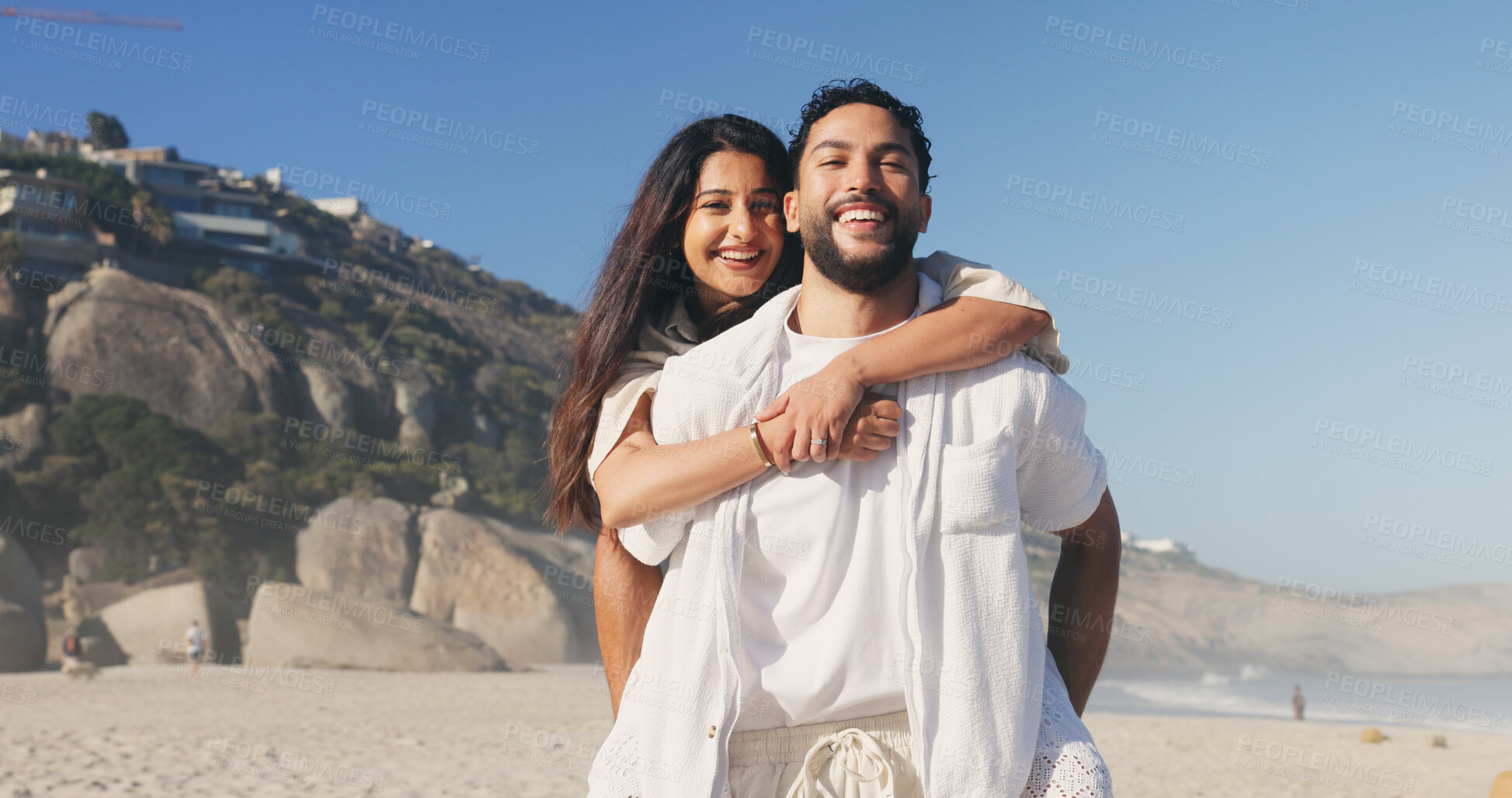 Buy stock photo Happy, hug and portrait of couple by beach on holiday, travel or getaway together for honeymoon. Smile, care and woman embrace man by ocean for seaside vacation for marriage, romance or love.
