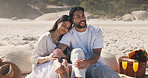 Couple, holding hands and picnic with smile at beach for romantic date, celebration or bonding together. Happy, people and embrace with flowers for romance, anniversary getaway and holiday at seaside