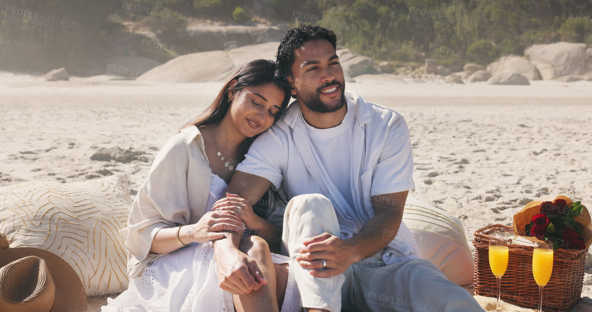 Buy stock photo Couple, holding hands and picnic with smile at beach for romantic date, celebration or bonding together. Happy, people and embrace with flowers for romance, anniversary getaway and holiday at seaside