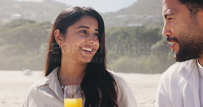Buy stock photo Smile, couple and relax with love at beach for romantic date, celebration and bonding together. Happy, people and picnic with orange juice for romance, anniversary getaway and holiday trip at seaside
