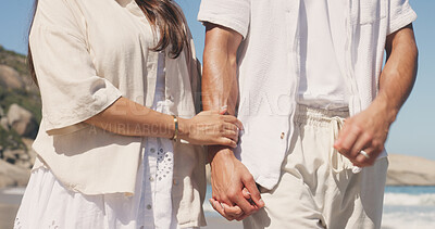 Buy stock photo Holding hands, couple and care on walk at beach with loyalty, holiday and love with bonding in summer. People, partner and relationship with marriage, honeymoon and connection on seaside vacation