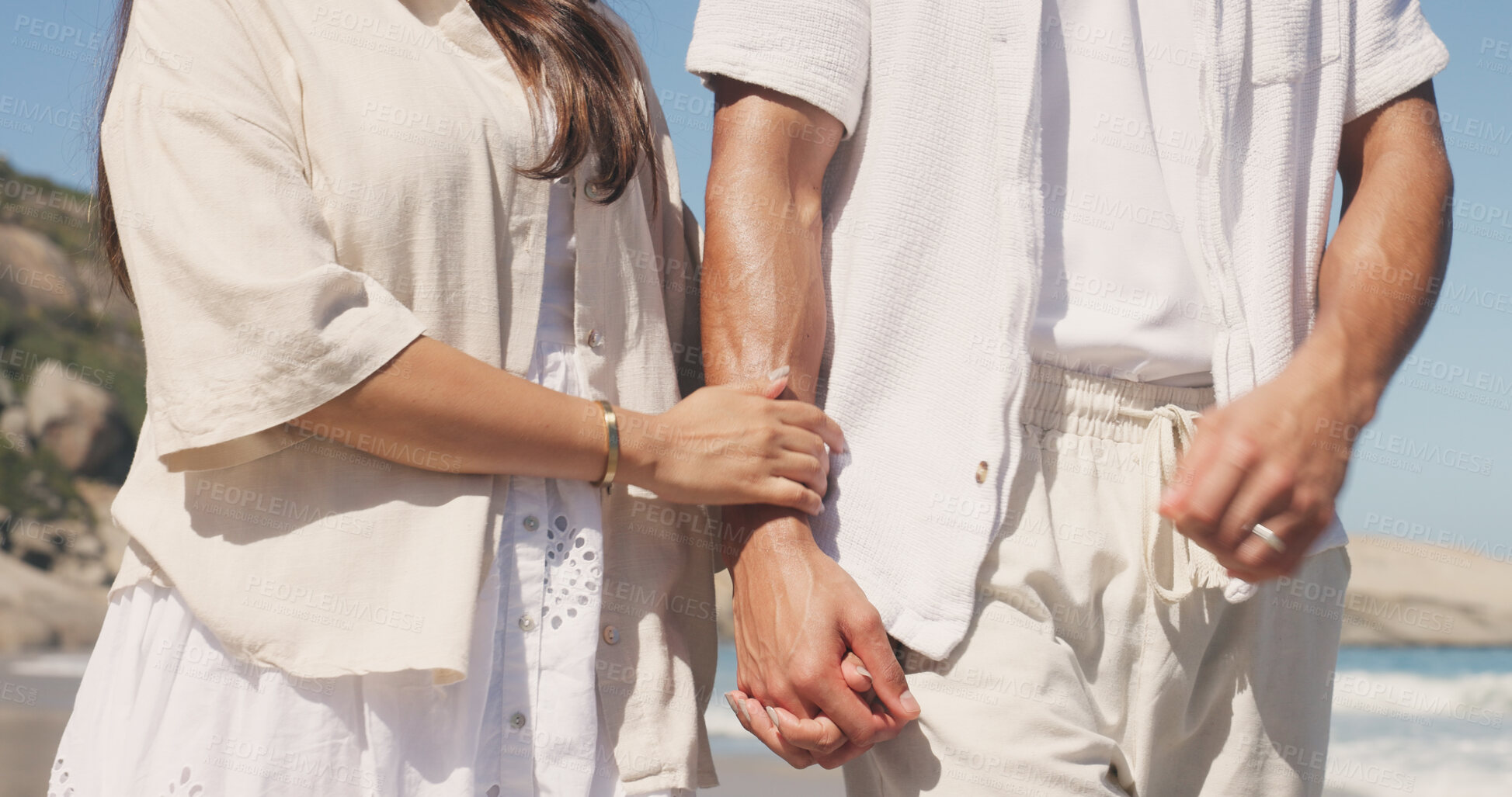 Buy stock photo Holding hands, couple and care on walk at beach with loyalty, holiday and love with bonding in summer. People, partner and relationship with marriage, honeymoon and connection on seaside vacation