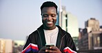Black man, fitness and phone with earphones in city for break, streaming service and audio with smile. African person, runner and smartphone on music app, subscription or rest for exercise in town