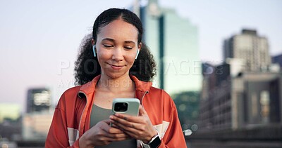 Buy stock photo Woman, fitness and phone with earphones in town for break, streaming service or smile for audio. Gen z girl, runner and listen to music on app, happy and rest with smartphone for exercise in city
