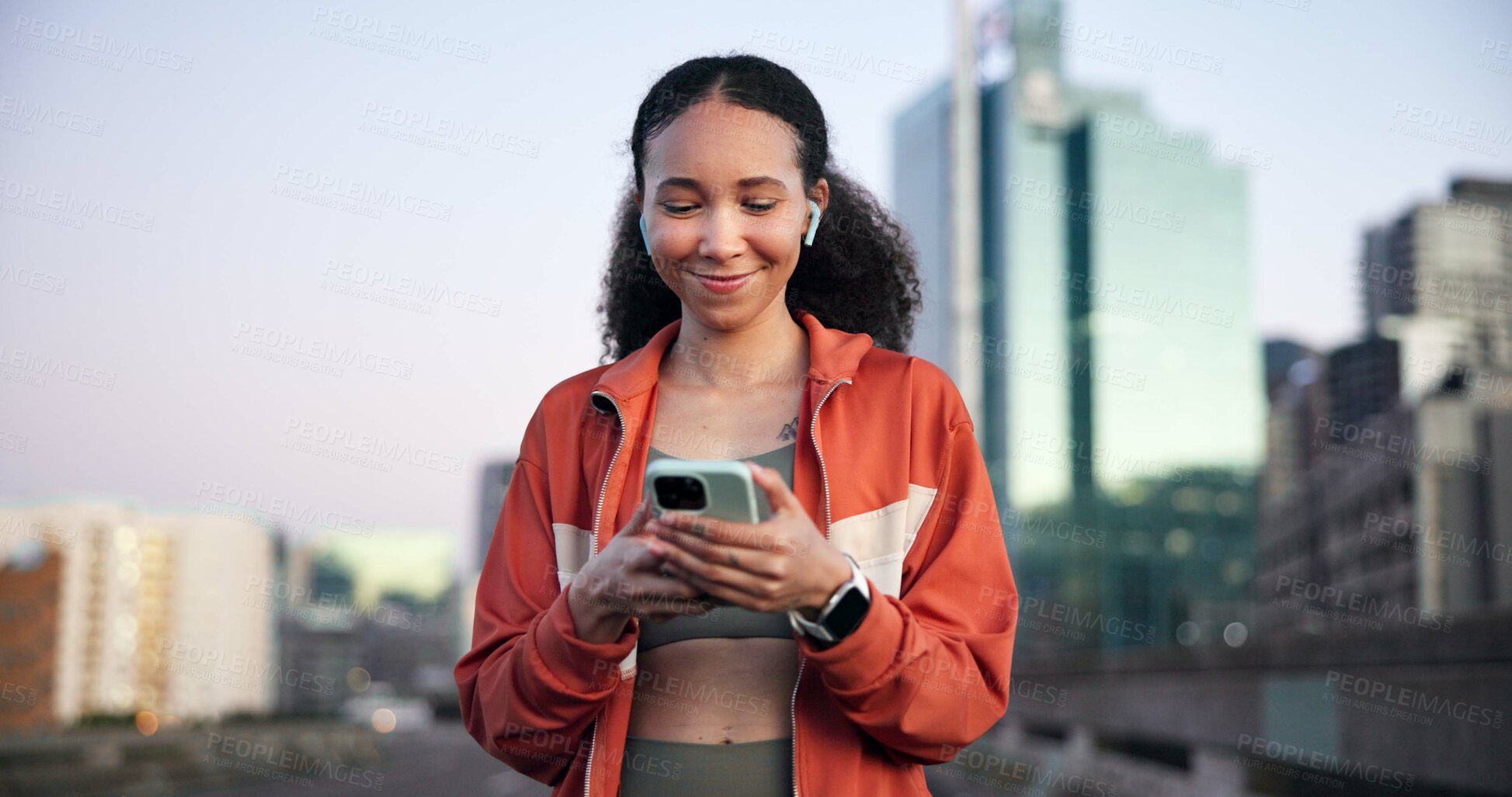 Buy stock photo Happy woman, fitness and phone with earphones in town on break, streaming and space on bridge. Gen z girl, runner and listen to music with app, smile or rest with smartphone for exercise in city