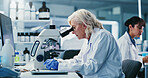 Woman, scientist and microscope with study at lab for notes, medical research and gloves for virus cure. Mature person, gear and sample with equipment, pharma or project for vaccine development