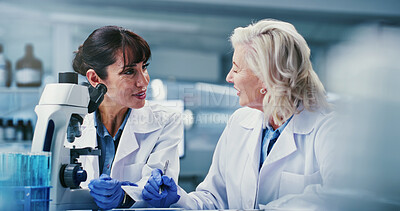Buy stock photo Science, women and discussion in lab with microscope, expert advice or experiment for medical research. Mature people, conversation and scientist in clinic with biotech, teamwork or healthcare trial.