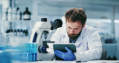 Buy stock photo Microscope, review or man with tablet in lab, medical research or pathology study for experiment report. Reading, trial results or scientist with tech for cure discovery, virus observation or record