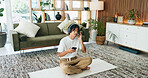 Yoga mat, music or man with phone in home for meditation song, sound and relax for calm. Mobile, headphones or Asian person on floor for fitness podcast, wellness audio or streaming with zen playlist