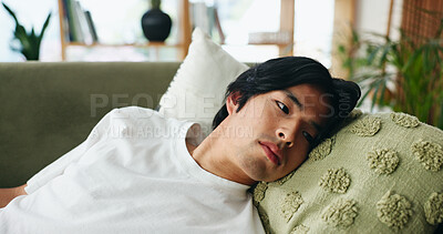 Buy stock photo Rest, thinking and tired with Asian man on sofa in home living room for break, morning or weekend. Comfortable, ideas and lazy with exhausted person in apartment lounge for afternoon nap or fatigue