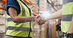 Business people, logistics and warehouse with handshake for teamwork or partnership together. Colleagues, employees or shaking hands with flare for shipping deal, b2b or onboarding in storage depot