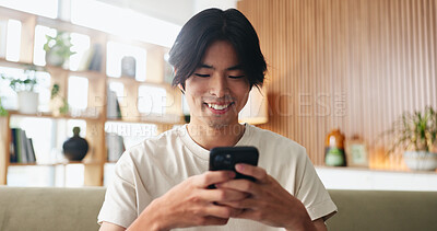 Buy stock photo Texting, smile or Asian man on sofa with phone, online chat or communication on dating site. Happy, conversation or person in house with tech, digital app or connection on matchmaking platform.
