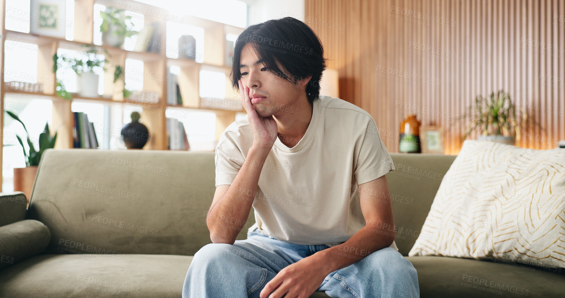 Buy stock photo Thinking, upset and man on sofa in home with regret for decision or choice with mental health. Anxiety, uncertain and Asian male person with reflection for mistake, failure or bad news in living room