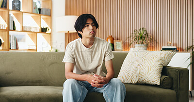 Buy stock photo Bored, man and thinking with regret on sofa for lazy day, doubt or mental health in home. Tired, male person or contemplating with thought or vision on living room couch for loneliness in house