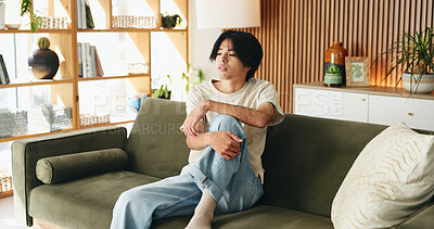 Buy stock photo Comfortable, man and thinking with Asian student on sofa in home living room for morning or weekend break. Planning, relax and vision with college or university pupil in apartment for education ideas