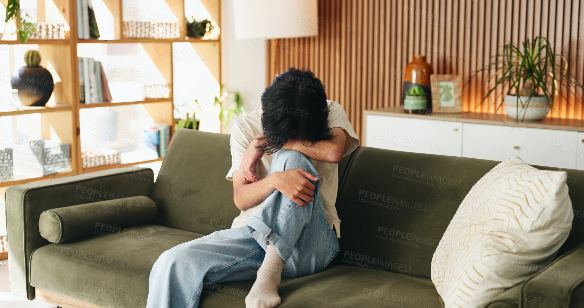 Buy stock photo Sad, anxiety and man in home with stress, loss and trauma with mental health challenge. Sofa, unhappy and person with depression in living room, loneliness crisis and mourning with grief in house