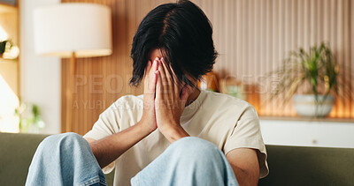 Buy stock photo Sad, trauma and man in home with stress, loss and anxiety for mental health challenge. Sofa, unhappy and person with depression in living room, loneliness crisis and mourning for grief in house