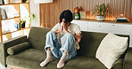 Frustrated, man and sofa with headache or anxiety for stress, mistake or mental health in home. Tired, exhausted or male person with depression, migraine or pain for regret or loneliness in house