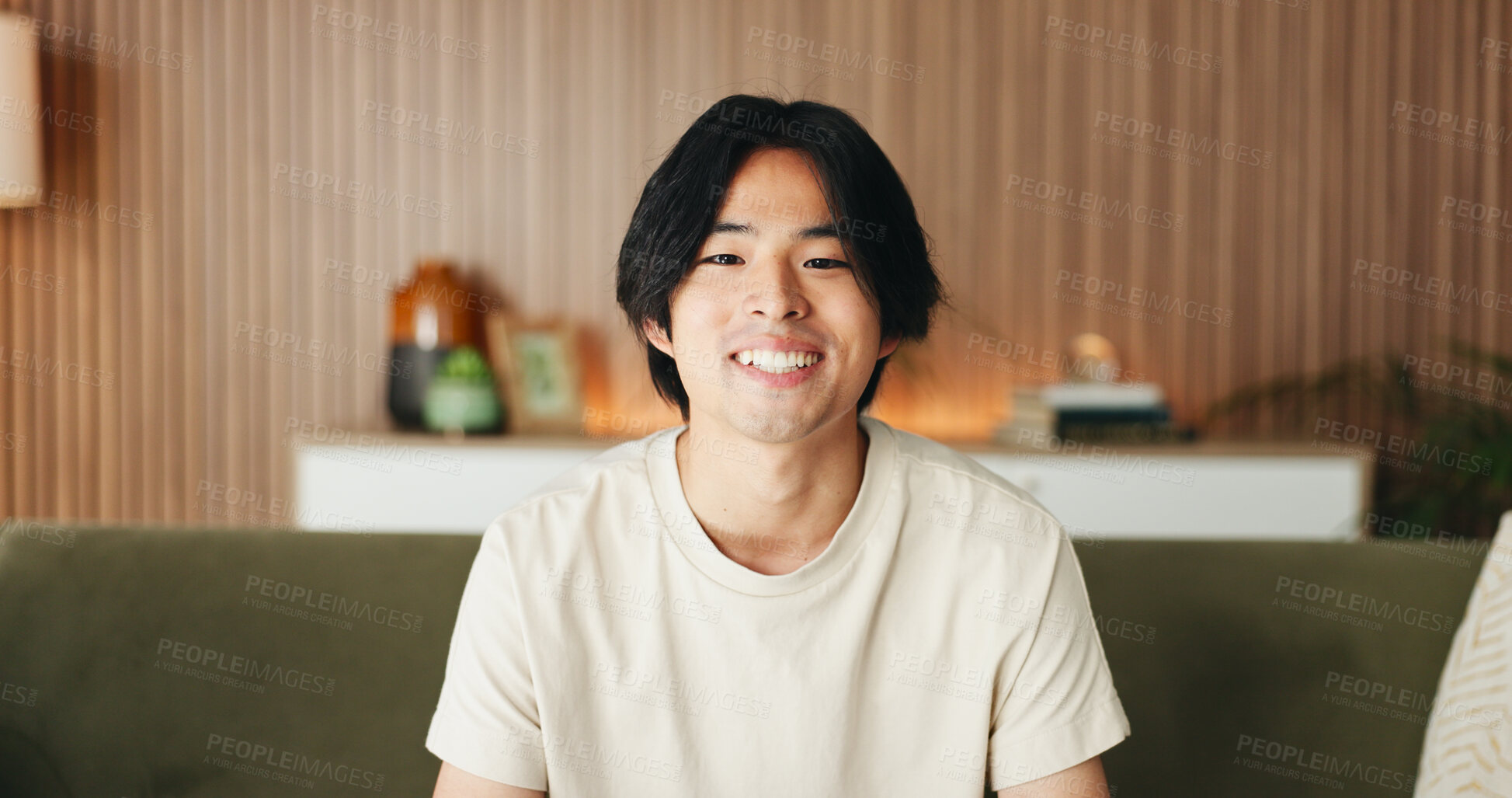 Buy stock photo Comfortable, portrait and relax with happy man on sofa in home living room for weekend break as student. Confidence, me time and smile with Asian university pupil on apartment couch in Japan