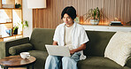 Laptop, relax and man on sofa in home with online application for university scholarship. Education, technology and Asian male student with computer for studying with college assignment in house. 