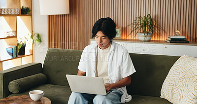 Buy stock photo Man, typing and remote work in house with laptop, digital marketing website or plan for campaign. Freelancer, person and research on sofa with computer, creativity or online branding for advertising.