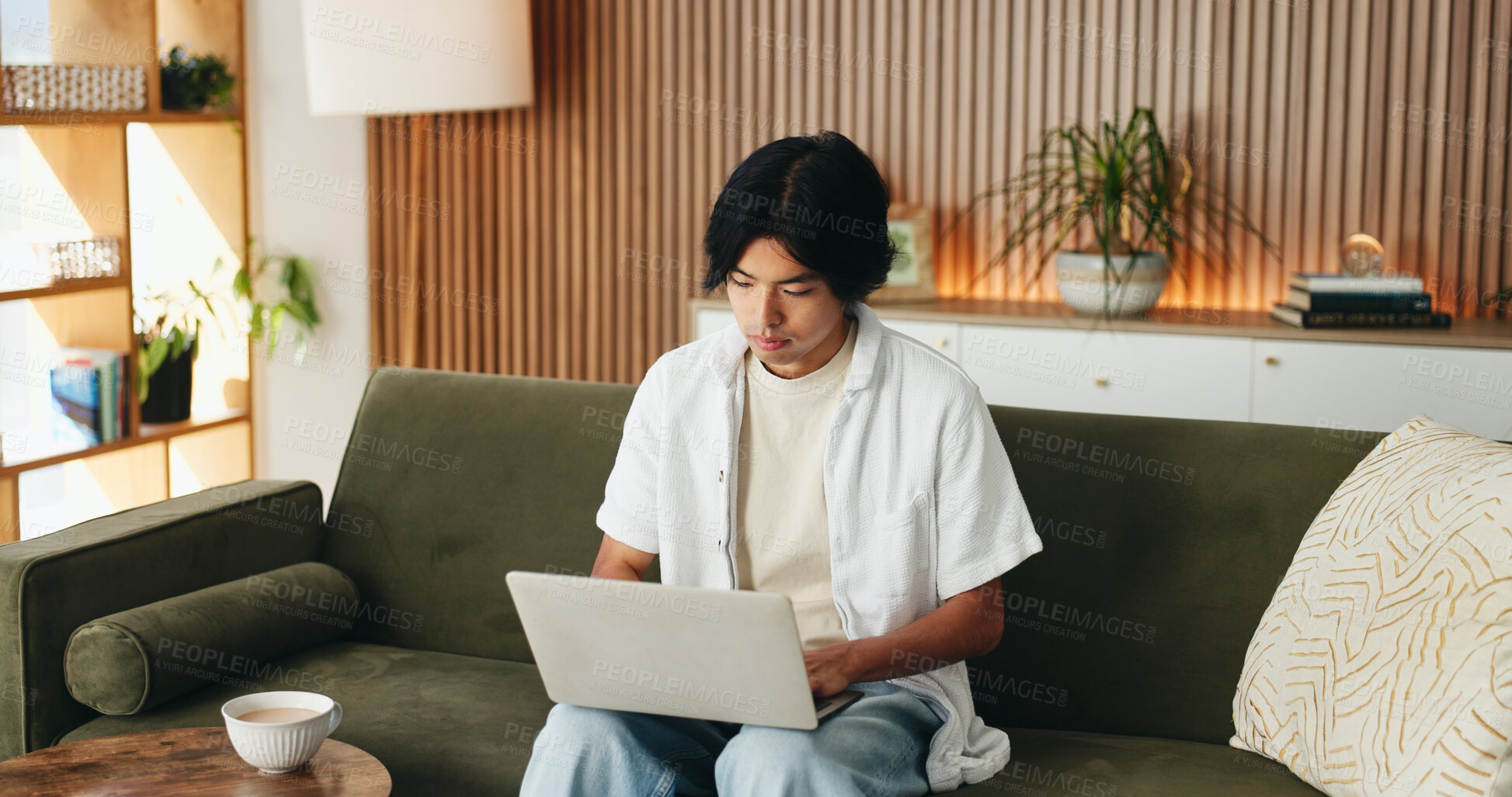Buy stock photo Man, typing and remote work in house with laptop, digital marketing website or plan for campaign. Freelancer, person and research on sofa with computer, creativity or online branding for advertising.