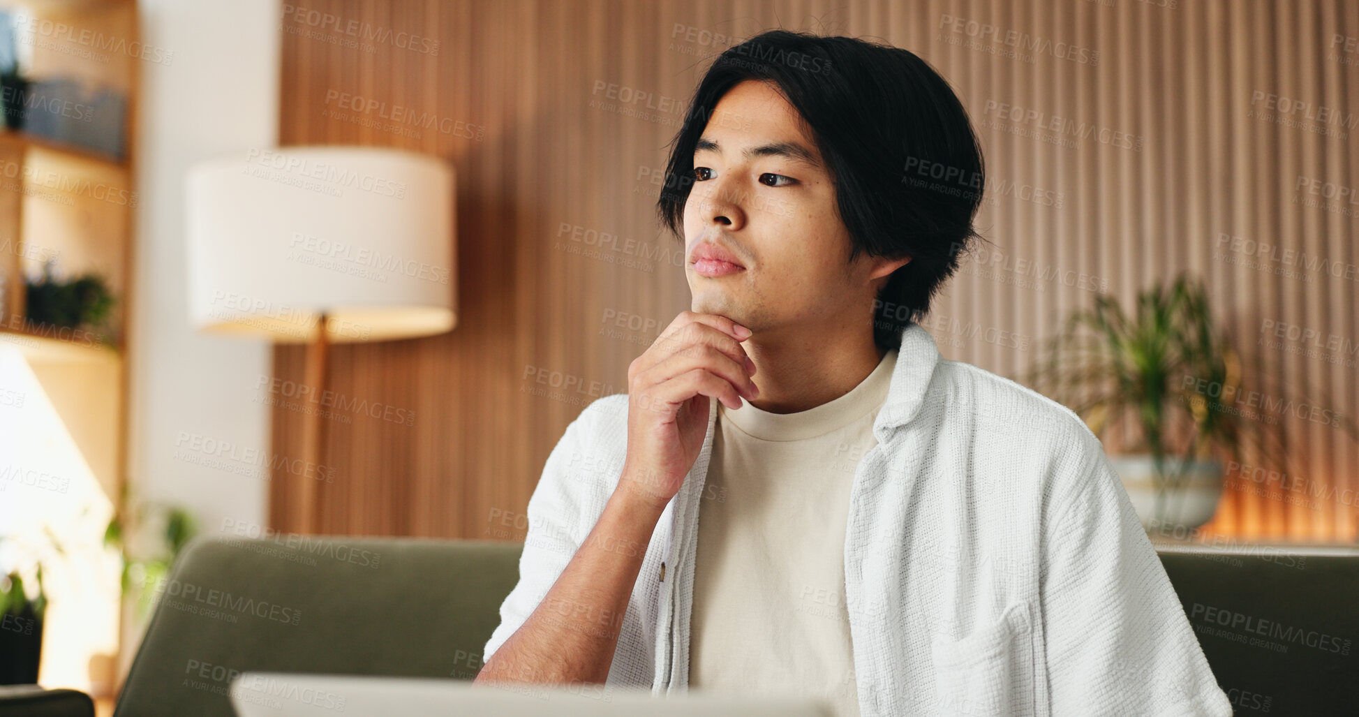 Buy stock photo Laptop, learning and thinking with Asian man on sofa in home living room for online education. Computer, planning and study review with college or university student in apartment for research ideas