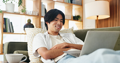 Buy stock photo Laptop, smile and study with Asian man on sofa in home living room for distance learning. Computer, online education and streaming with happy university student in apartment for development or growth